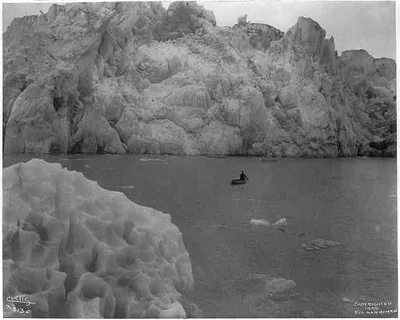 [Man in canoe in front of Muir Glacier, Alaska], 1899