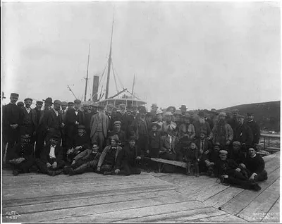 [Large group of men and women on dock in front of ship, Alaska or the…, 1899