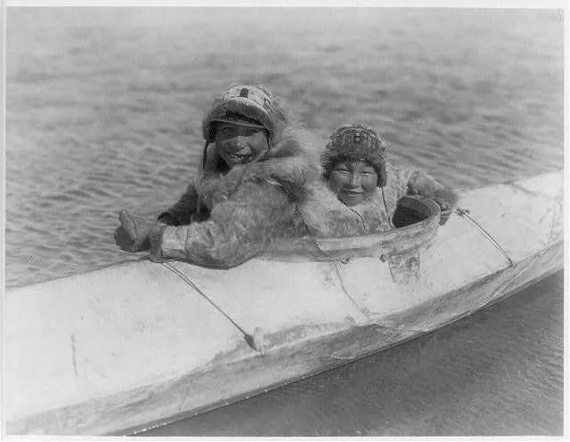 Boys in a kaiak (i.e., kayak)--Nunivak, Alaska, Nunivak Island, 1929