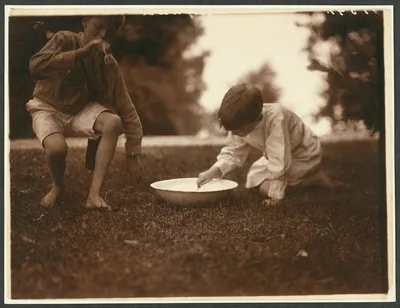 Archie & Quentin making the suds for soap bubbler, Oyster Bay, New York, 1904
