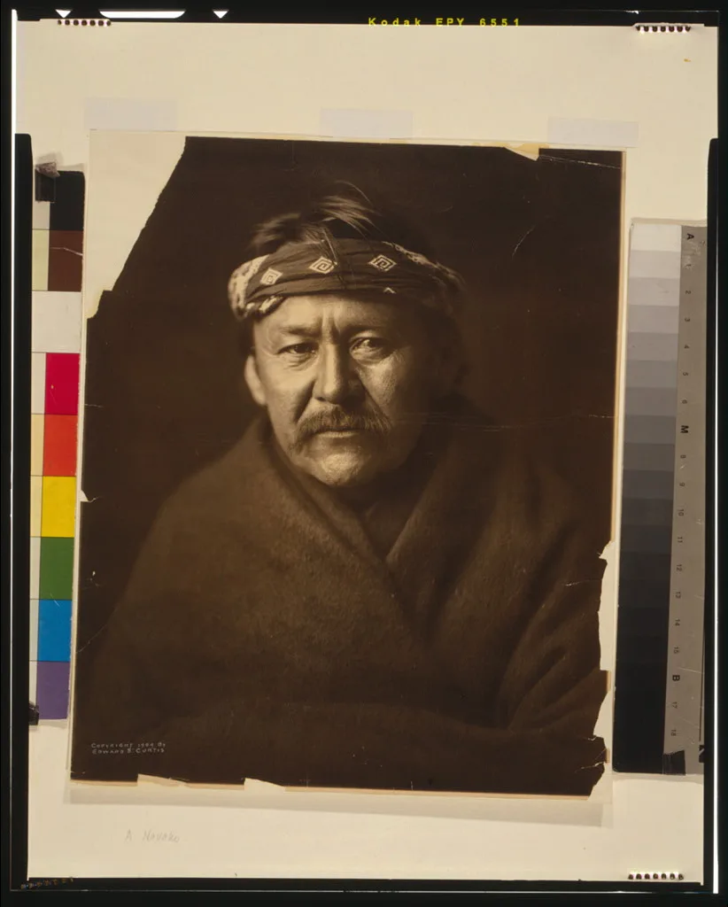 [A Navajo man, head-and-shoulders portrait, wearing blanket and…, 1904