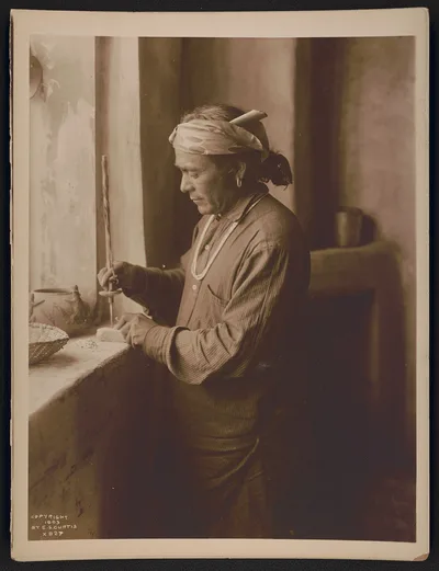 [Zuni Indian bead worker drilling holes in beads], New Mexico, Zuni, 1908