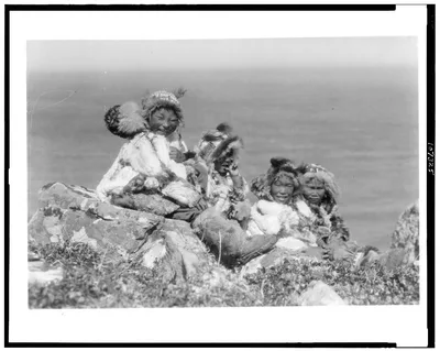 [Four Eskimo children, at edge of cliff, in holiday costume, Nunivak,…, Alaska, Nunivak, 1929