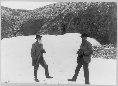 [John Muir and John Burroughs, full-length portrait, standing on snow], 1899